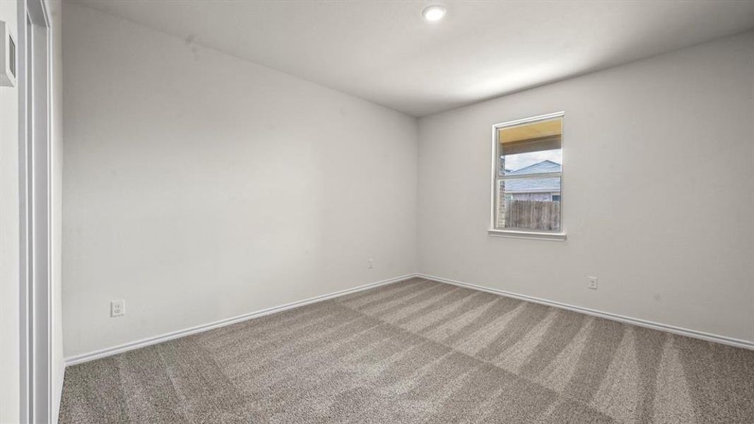 Carpeted room featuring a single window, recessed lighting, white baseboards, and neutral wall paint