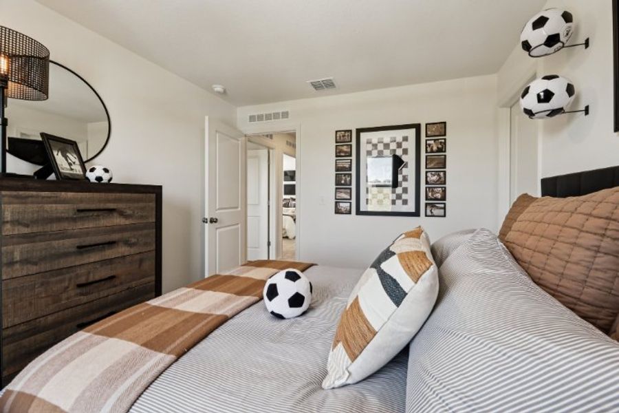 A room with a bed and a pillow with a panda face on it. A room with a bed and a pillow with a panda face on it.