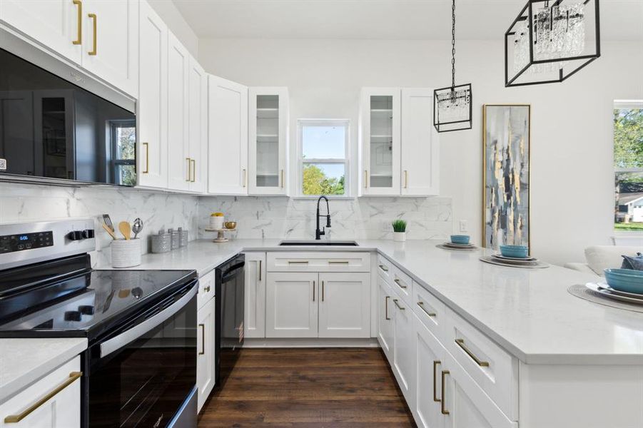 All white kitchen featuring tasteful backsplash, a peninsula, dishwasher, and electric range All white kitchen featuring tasteful backsplash, a peninsula, dishwasher, and electric range