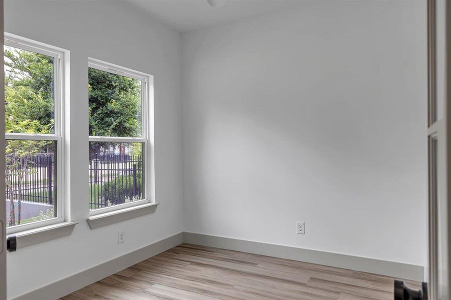 Empty room featuring light wood-style flooring and baseboards Empty room featuring light wood-style flooring and baseboards