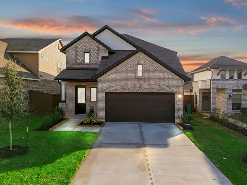 Front exterior of a new home in The Trails, New Caney, TX, highlighting curb appeal (Image 2). Front exterior of a new home in The Trails, New Caney, TX, highlighting curb appeal (Image 2).