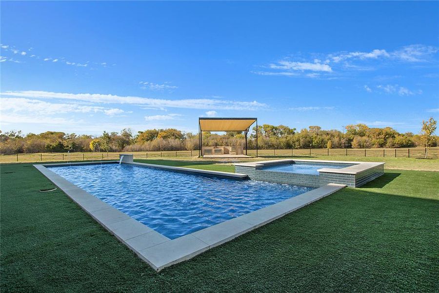 View of swimming pool with a lawn