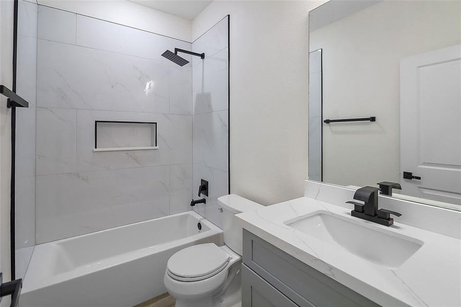 Step into a sanctuary of modern elegance—this secondary bathroom, where contemporary design meets practical functionality in a space designed for comfort and style.