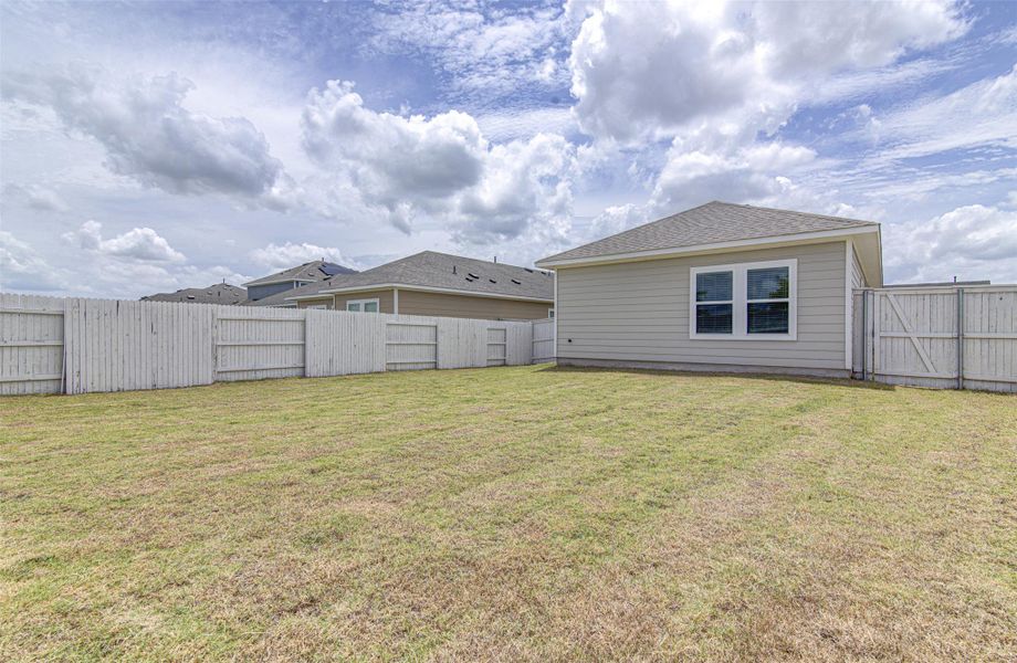 A spacious backyard awaits, fully fenced for privacy and outdoor enjoyment. A spacious backyard awaits, fully fenced for privacy and outdoor enjoyment.