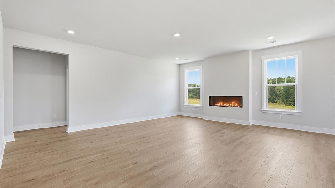 Memorable moments begin in this elegant, open family room with hardwood flooring and refined finishes at Pinebrook