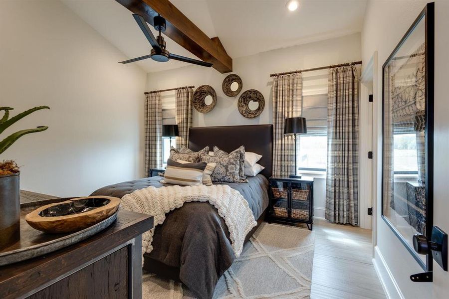 Bedroom with ceiling fan, light hardwood / wood-style flooring, and lofted ceiling with beams
