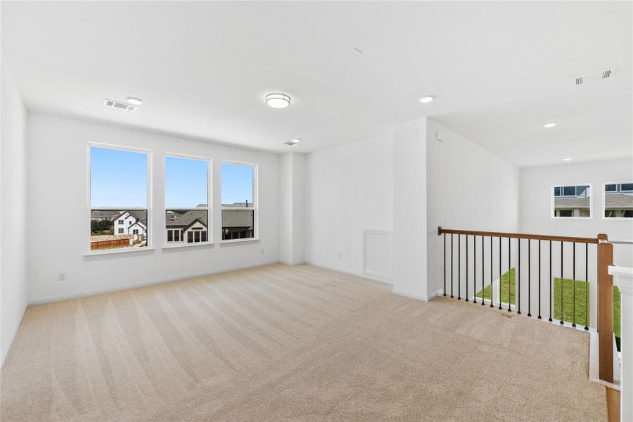 Spare room with light carpet and baseboards