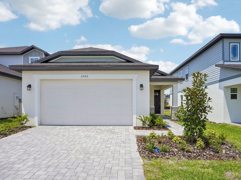 Front exterior of a new home in Cyrene at Minneola, Minneola, FL, highlighting curb appeal (Image 1). Front exterior of a new home in Cyrene at Minneola, Minneola, FL, highlighting curb appeal (Image 1).