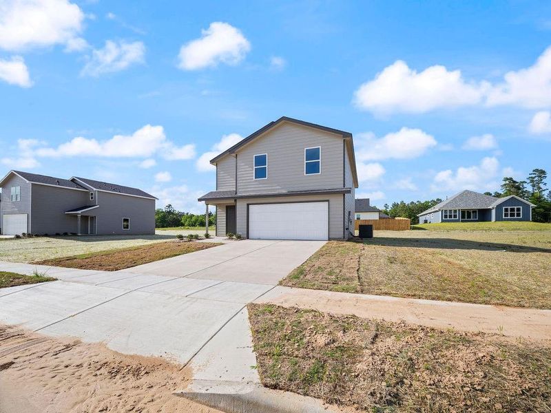 Front exterior of a new home in Stoney Ridge, Hudson, TX, highlighting curb appeal (Image 15).