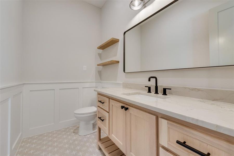 Bathroom featuring tile flooring, vanity, and toilet