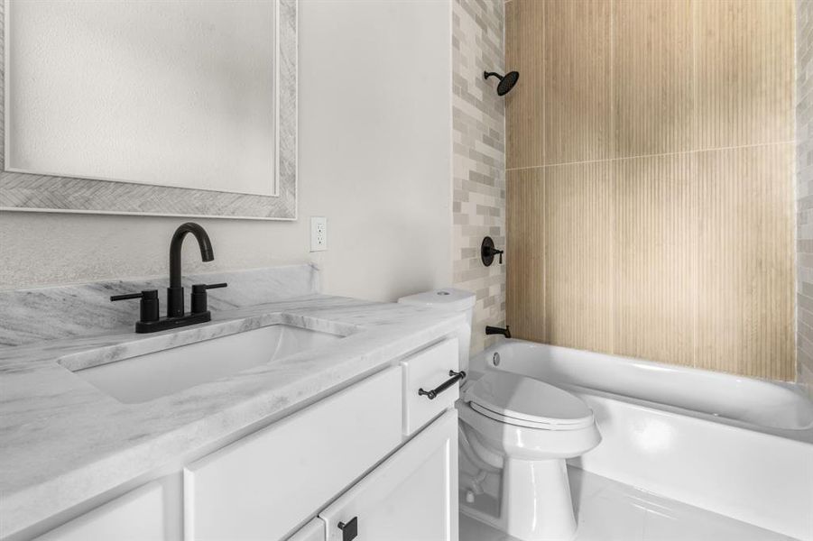 Full bathroom featuring vanity and bathing tub / shower combination