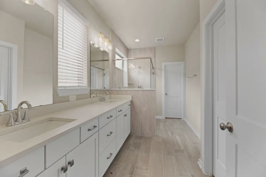 Representative furnished interior of a home built from the Sedona by Chesmar Homes in Sunterra, Katy (Image 5).