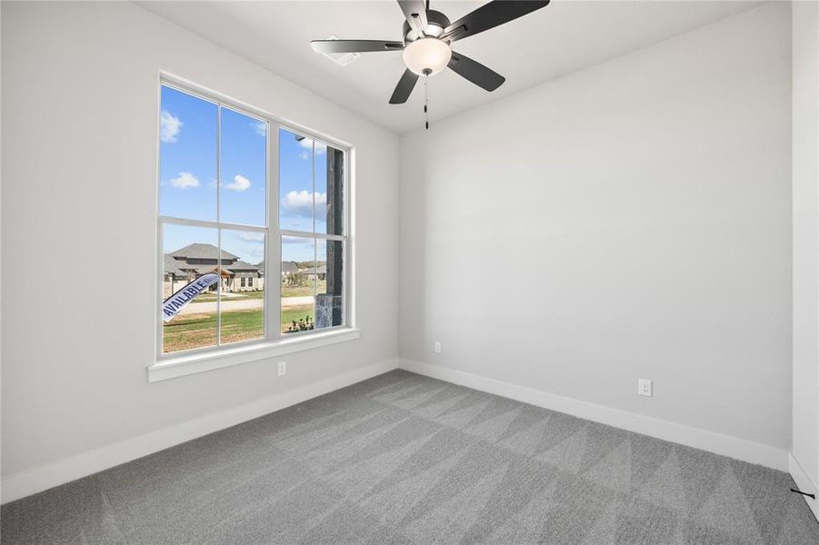 Unfurnished room with ceiling fan and light colored carpet
