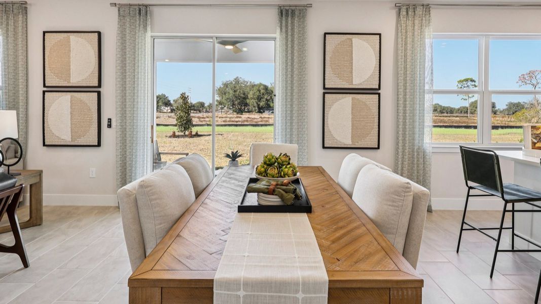 The Mangrove Model Dining Area on the first floor at Lakeside at Satilla by DRB Homes in Saint Cloud, FL