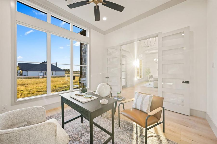 Office space with light wood-style flooring, a ceiling fan, and hanging lights Office space with light wood-style flooring, a ceiling fan, and hanging lights