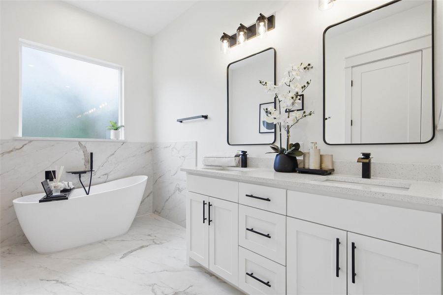 A well-lit primary bathroom featuring a freestanding soaking tub and a spacious double vanity with ample storage. A well-lit primary bathroom featuring a freestanding soaking tub and a spacious double vanity with ample storage.