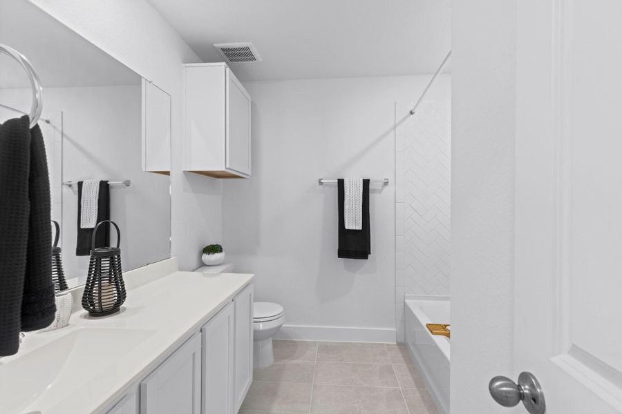 The full upstairs bathroom is designed with convenience and style in mind, featuring a cultured marble countertop, single-sink vanity with storage, and a tub/shower combo with crisp tile surround. **Image Representative of Plan Only and May Vary as Built**.