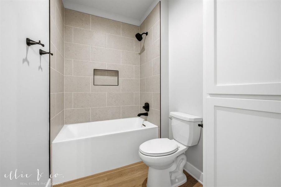 Full bathroom featuring tub / shower combination and wood finished floors