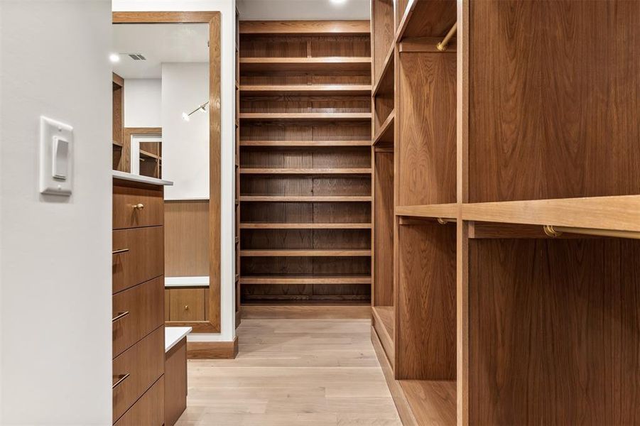 The custom walk in closet is thoughtfully designed with built in storage that keeps everything organized and easy to access