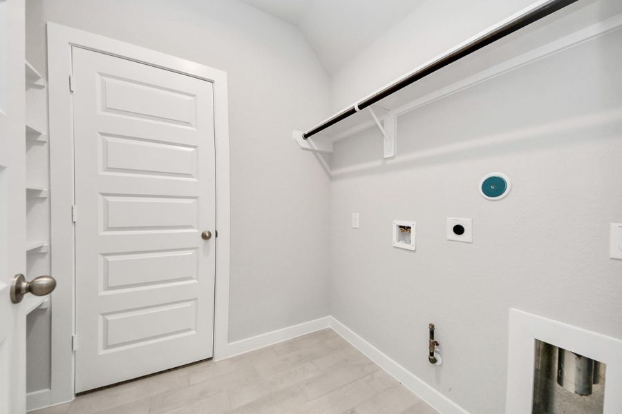 A perfect blend of functionality and comfort. Capture the essence of easy living with a first-floor laundry room, thoughtfully equipped with shelving for effortless organization. Both electric and gas connections available.