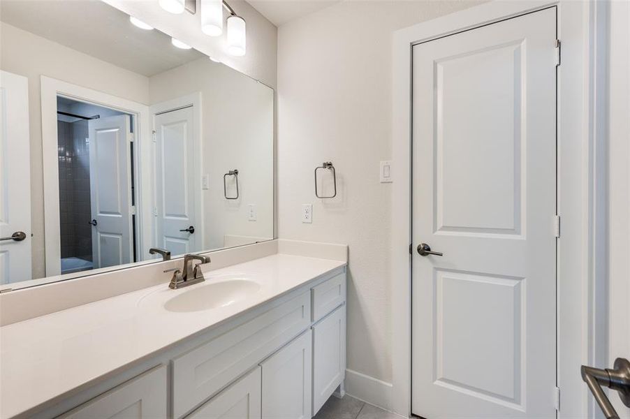 Full bath with vanity and baseboards Full bath with vanity and baseboards