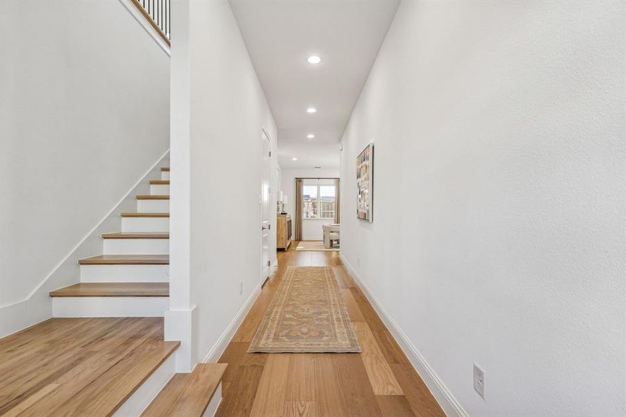 Hallway with recessed lighting and light wood-style floors