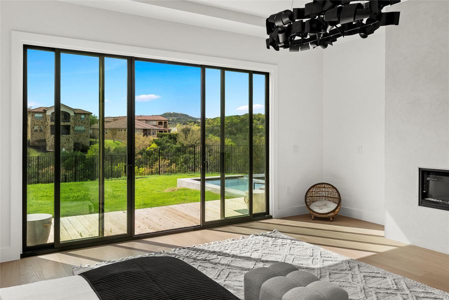 Doorway to outside featuring wood finished floors and hanging lights Doorway to outside featuring wood finished floors and hanging lights