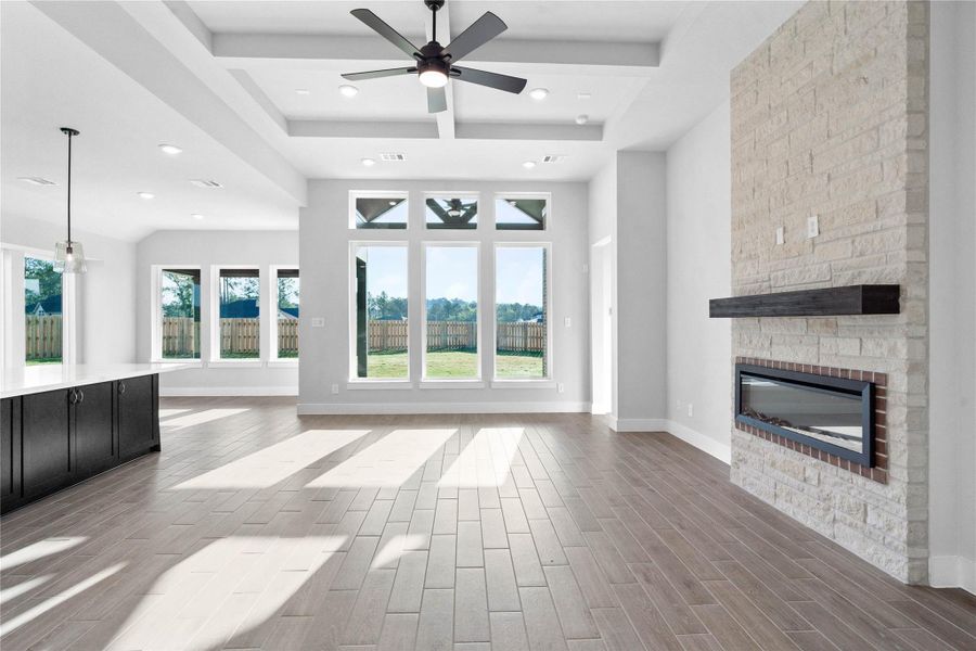 Bright and inviting living space featuring an open-concept design, soaring ceilings, and expansive windows that flood the room with natural light. Wide plank flooring and a seamless flow to the kitchen and dining areas create an ideal setting for both relaxed living and effortless entertaining. Bright and inviting living space featuring an open-concept design, soaring ceilings, and expansive windows that flood the room with natural light. Wide plank flooring and a seamless flow to the kitchen and dining areas create an ideal setting for both relaxed living and effortless entertaining.