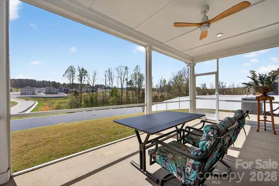 Spacious covered, screened patio with recessed lighting and fan overlooks the clean backyard.