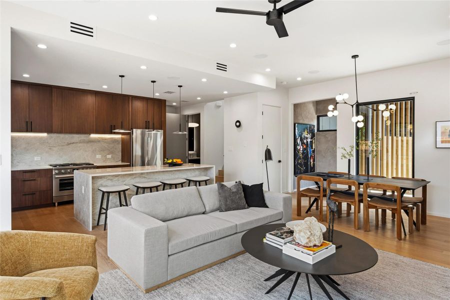 An open-concept living area boasts a sleek kitchen, comfortable lounge space, and a dedicated dining nook.