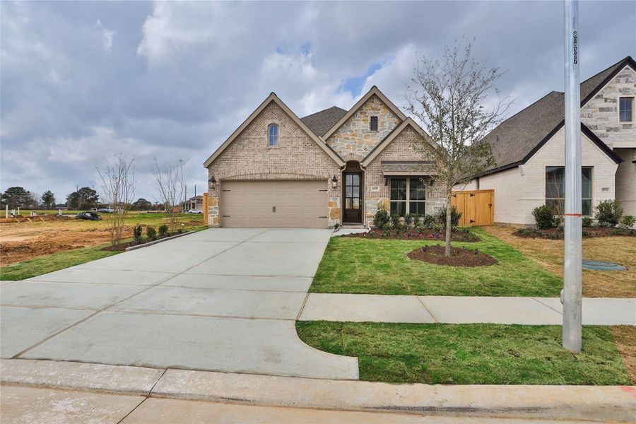 Front exterior of a new home in Everly, Hockley, TX, highlighting curb appeal (Image 2).