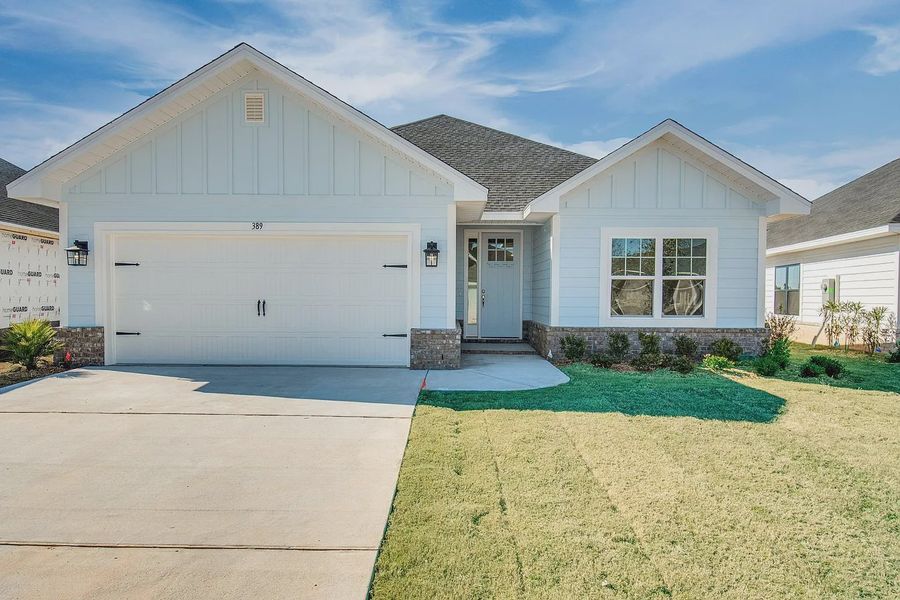 Front exterior of a new home in The Bluffs at Lafayette, Freeport, FL, highlighting curb appeal (Image 1). Front exterior of a new home in The Bluffs at Lafayette, Freeport, FL, highlighting curb appeal (Image 1).
