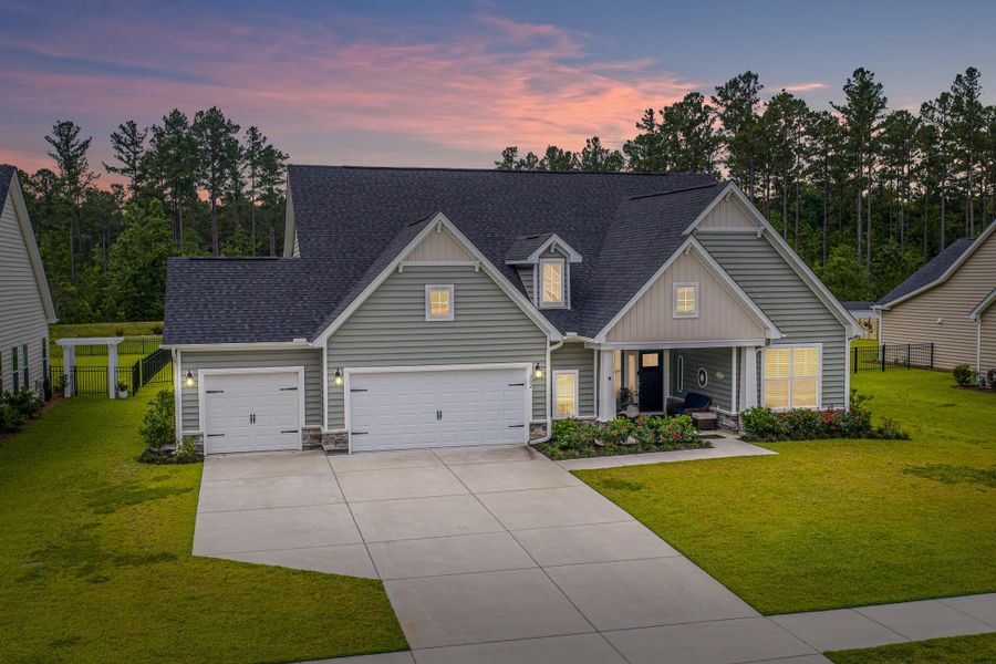 Front exterior of a new home in The Enclave at French Quarter Creek, Huger, SC, highlighting curb appeal (Image 25). Front exterior of a new home in The Enclave at French Quarter Creek, Huger, SC, highlighting curb appeal (Image 25).