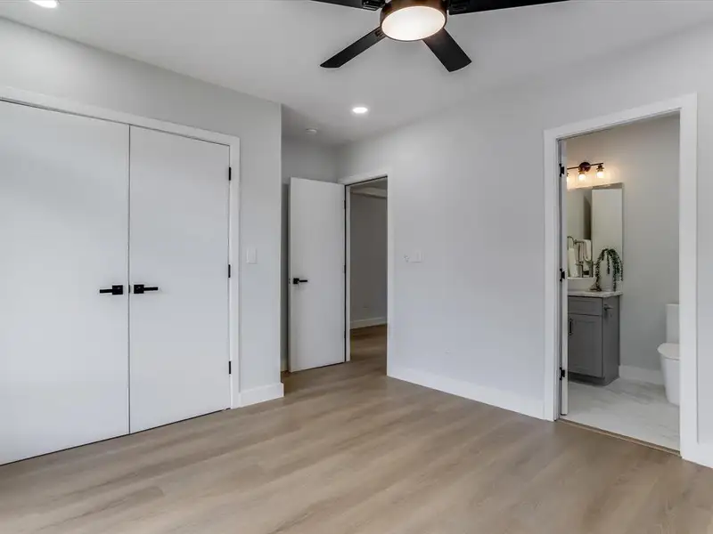 Spacious room featuring wood-finish flooring, recessed lighting, and a ceiling fan Spacious room featuring wood-finish flooring, recessed lighting, and a ceiling fan