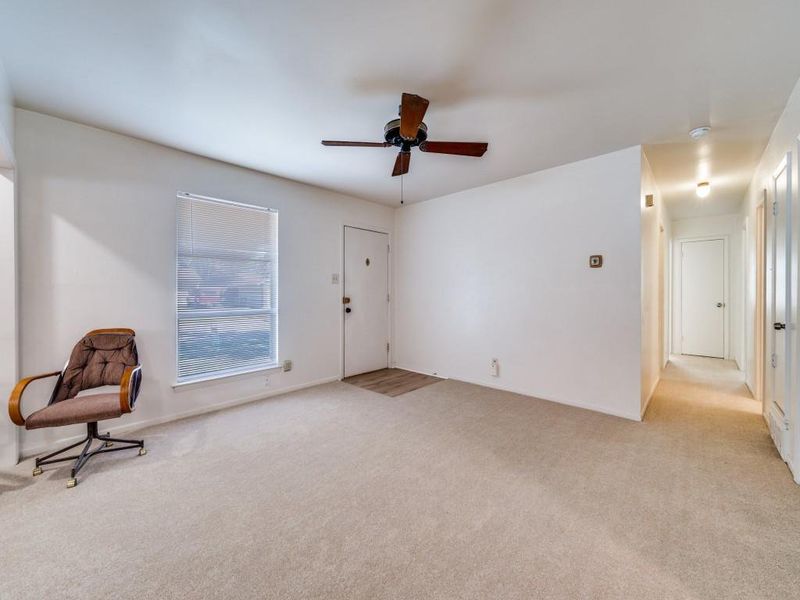 Unfurnished room featuring light carpet and ceiling fan Unfurnished room featuring light carpet and ceiling fan