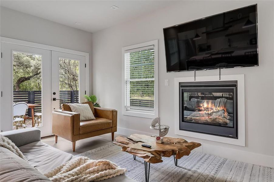 A cozy living space features an inset fireplace, inviting warmth and relaxation.