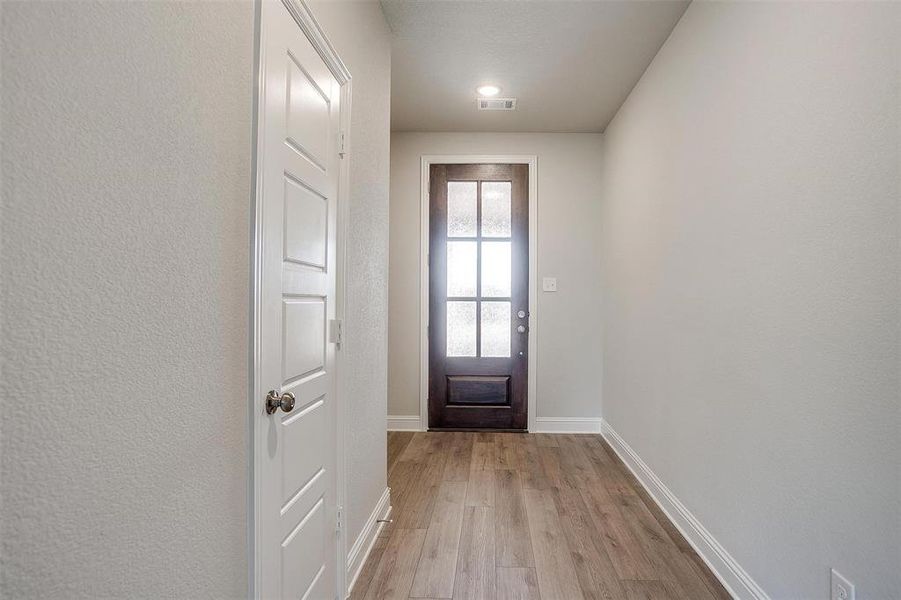 Doorway to outside featuring light wood-type flooring