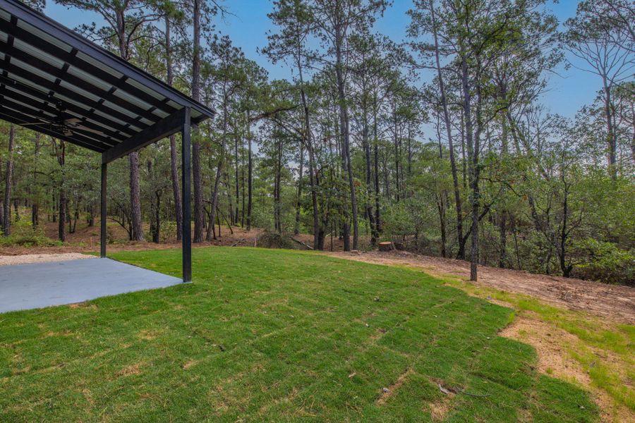 Covered patio with a mounted ceiling fan overlooking a newly sodded lawn Covered patio with a mounted ceiling fan overlooking a newly sodded lawn