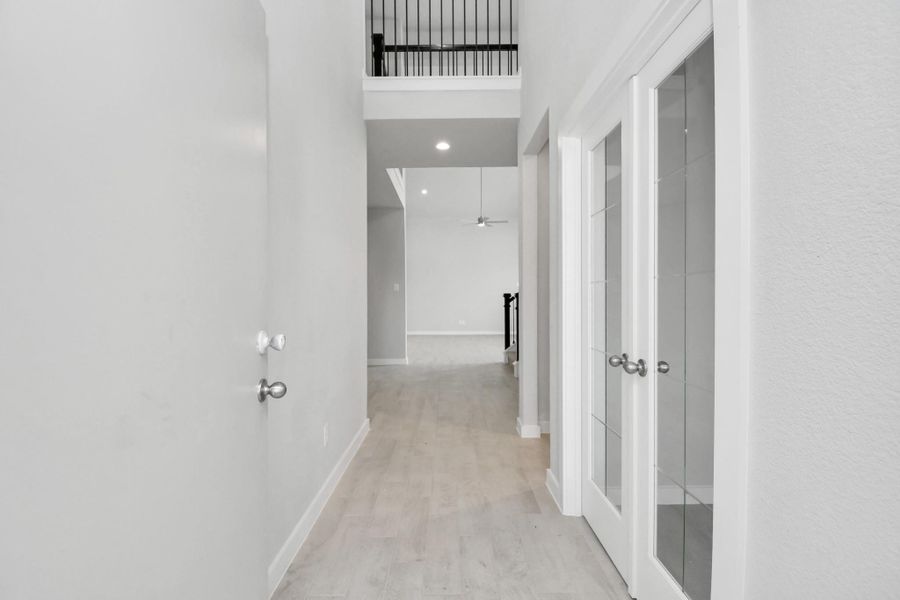 As you step into the threshold of this luxurious home, you'll soon be welcomed by an elegant glass door (to be installed). Inside, soaring ceilings amplify the spaciousness, while the refined wood-look tile flooring and oversized baseboards exude sophistication and charm. Sample photo of completed home with similar floor plan. Actual colors and selections may vary. As you step into the threshold of this luxurious home, you'll soon be welcomed by an elegant glass door (to be installed). Inside, soaring ceilings amplify the spaciousness, while the refined wood-look tile flooring and oversized baseboards exude sophistication and charm. Sample photo of completed home with similar floor plan. Actual colors and selections may vary.