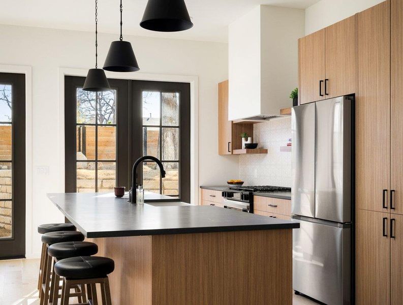 Quartz counters, pendant lighting and stainless appliances adorn the kitchen. Quartz counters, pendant lighting and stainless appliances adorn the kitchen.
