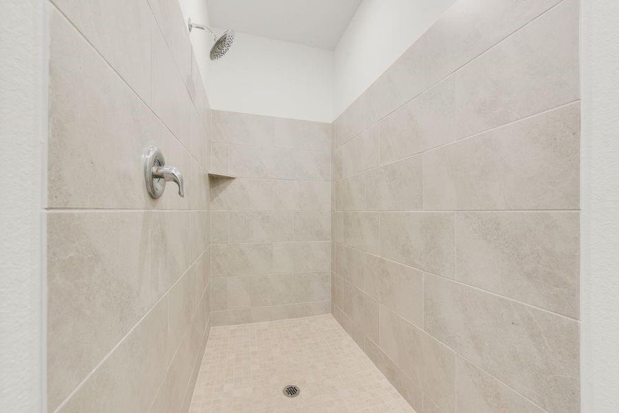 Full bath featuring tiled shower Full bath featuring tiled shower
