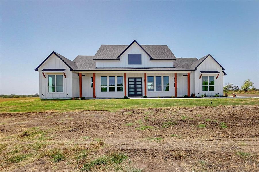 Modern farmhouse style home with a front yard