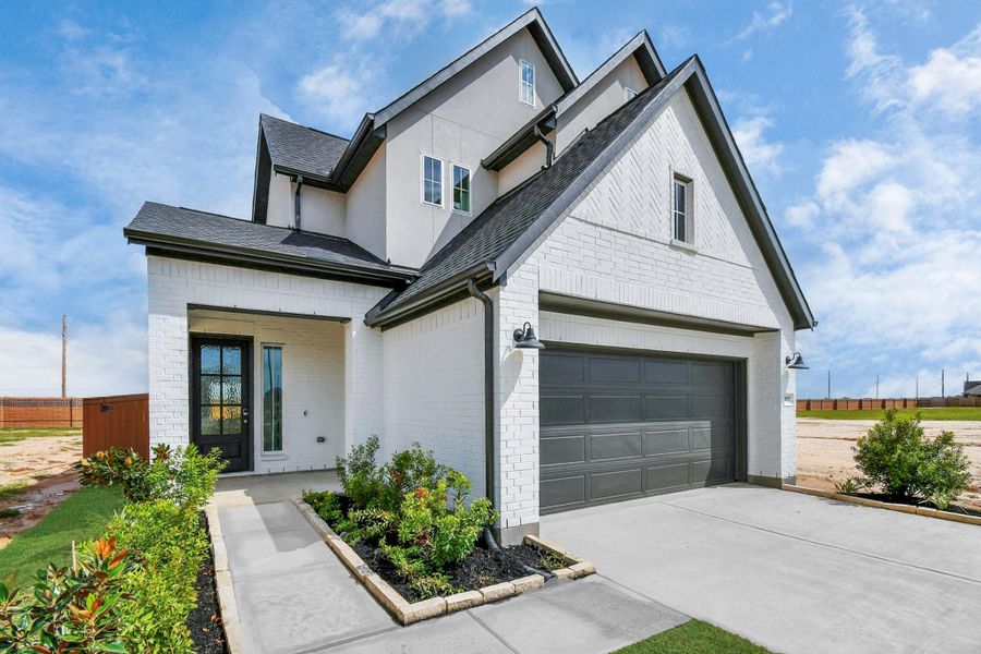 Front exterior of a new home in Elyson, Katy, TX, highlighting curb appeal (Image 21).