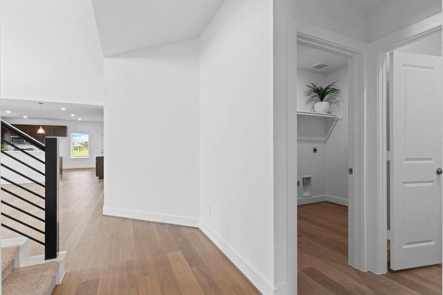 Opposite the study, the wide entry foyer opens into the main living area with a dramatic wrought iron staircase and open sightlines into the family room. The seamless flow and elegant finishes offer a warm, stylish welcome to guests and residents alike. The first floor has upgrade beautiful durable, waterproof Rigid Core vinyl wood plank flooring throughout the first floor! **Image Representative of Plan Only and May Vary as Built**. Opposite the study, the wide entry foyer opens into the main living area with a dramatic wrought iron staircase and open sightlines into the family room. The seamless flow and elegant finishes offer a warm, stylish welcome to guests and residents alike. The first floor has upgrade beautiful durable, waterproof Rigid Core vinyl wood plank flooring throughout the first floor! **Image Representative of Plan Only and May Vary as Built**.