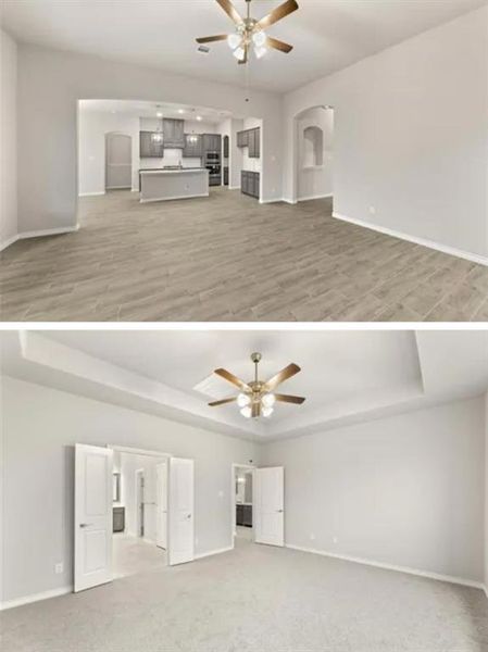 Unfurnished living room with a tray ceiling, light hardwood / wood-style flooring, and ceiling fan