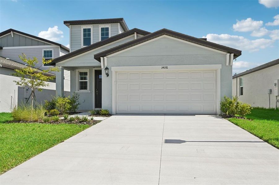 Front exterior of a new home in Salt Meadows - Premier Series, Parrish, FL, highlighting curb appeal (Image 1).