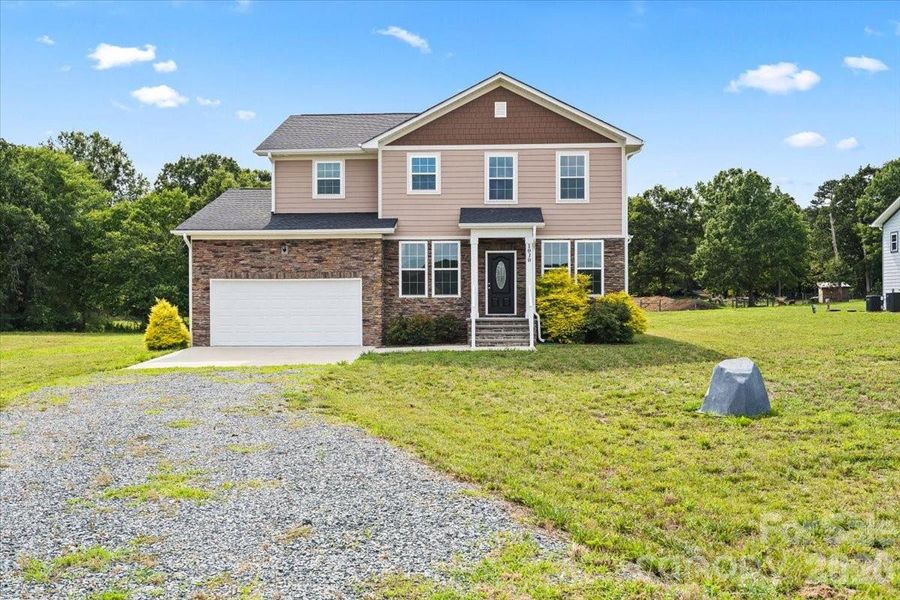 Front exterior of a new home in , Monroe, NC, highlighting curb appeal (Image 23).