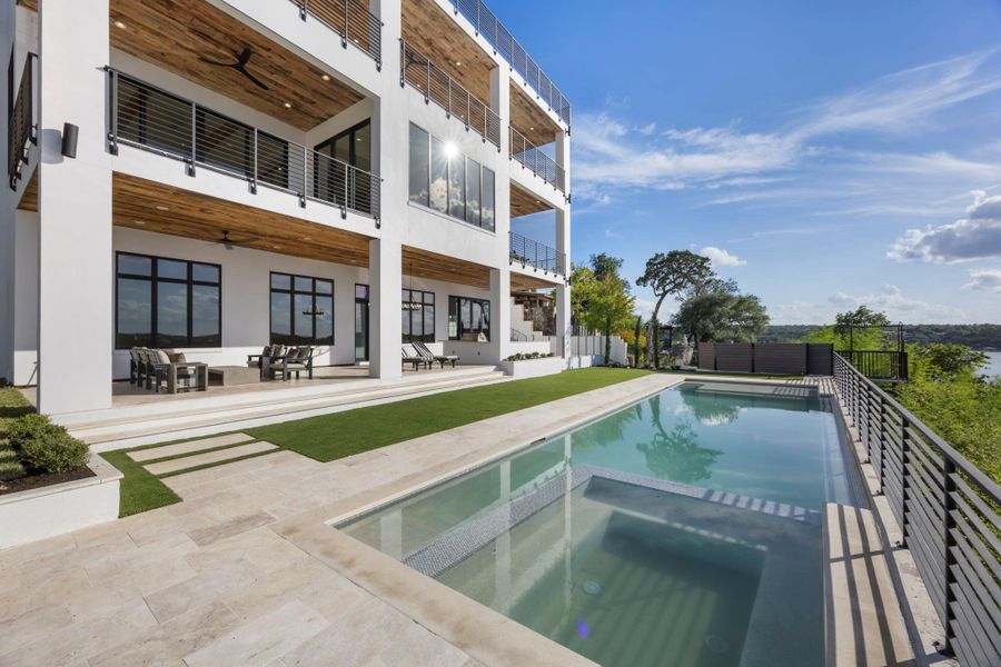 An exquisite multi-story residence with a glistening private pool overlooking a scenic lake vista. An exquisite multi-story residence with a glistening private pool overlooking a scenic lake vista.