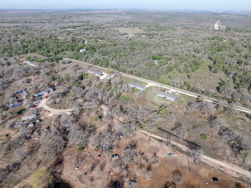 Aerial overview of property's location with a forest Aerial overview of property's location with a forest