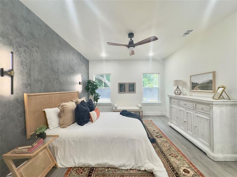 Bedroom with ceiling fan and light hardwood / wood-style flooring